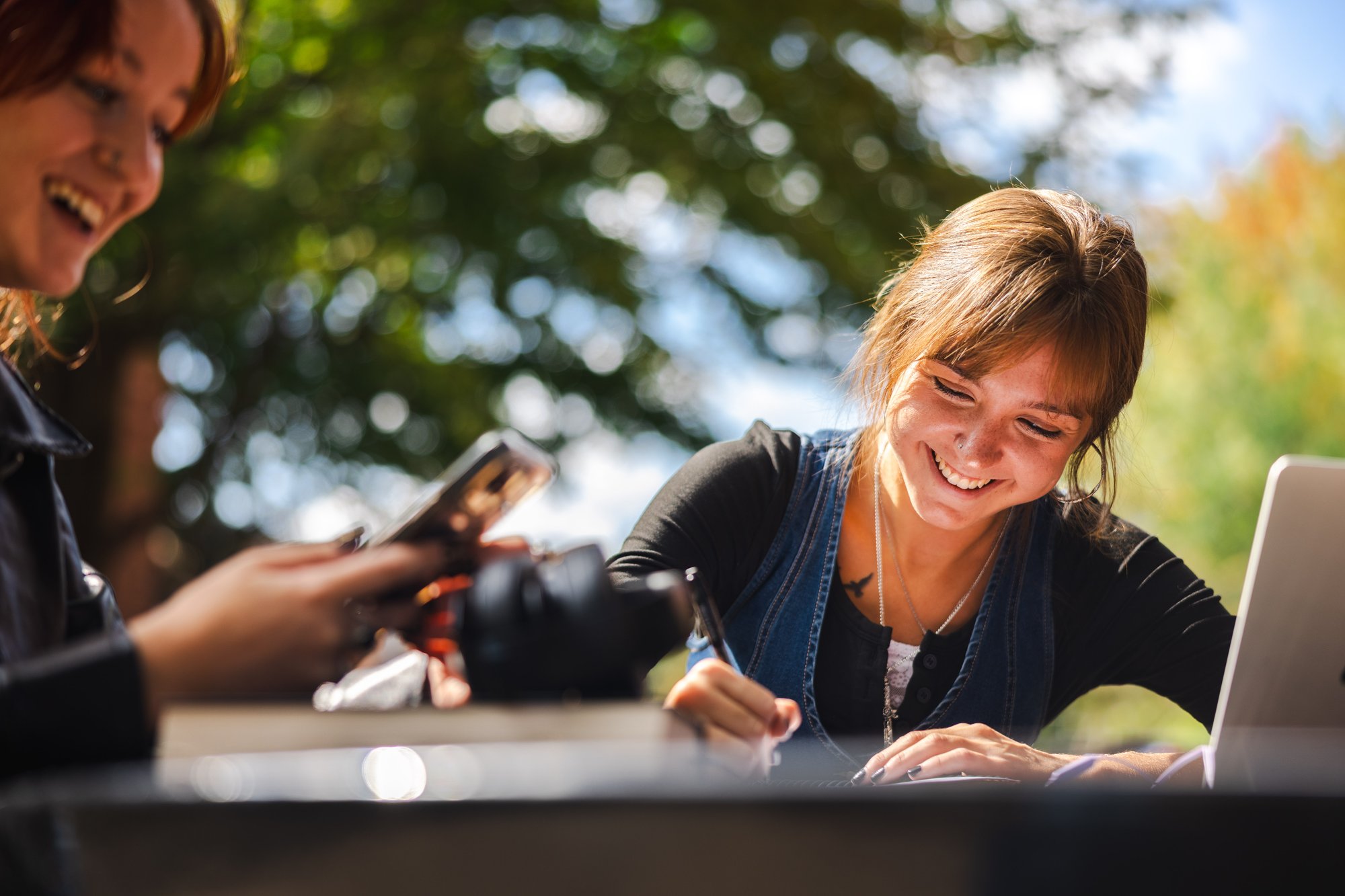 Brown head girl filling out a form at a table